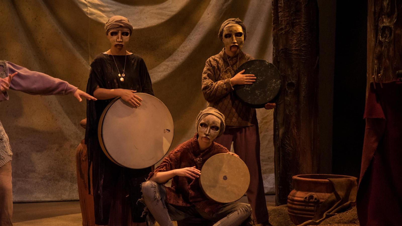 Three actors in masks perform Hecuba