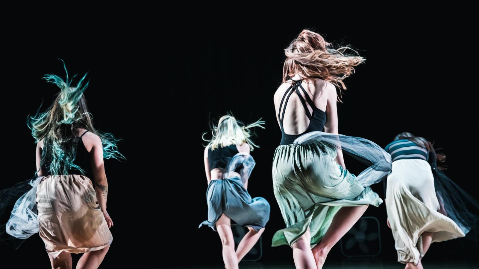 Four dancers in long skirts