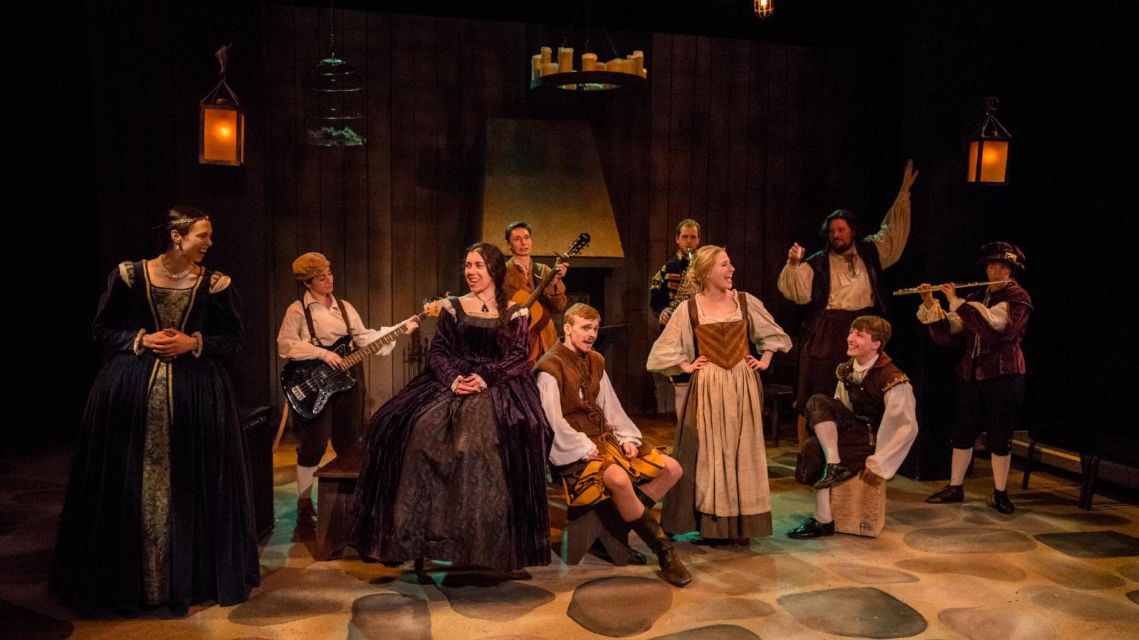 a group of student actors sing and play instruments