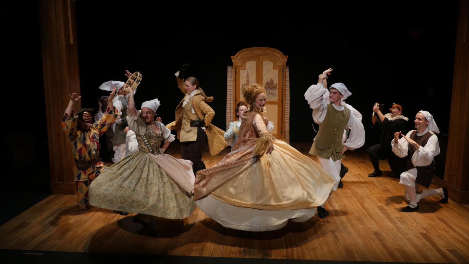 student actors dance on stage