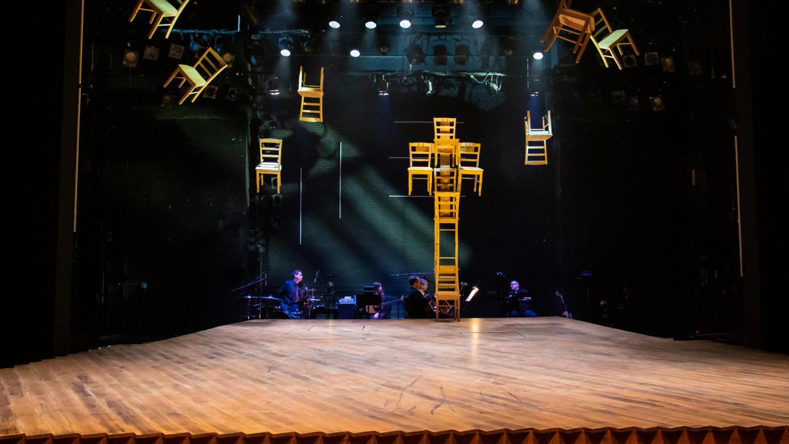 chairs are affixed to the ceiling of a stage