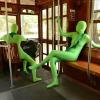 People in green suits sitting on trolley