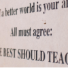 Wall sign for Best Should Teach reading "if a better world is your aim, all must agree: the best should teach."