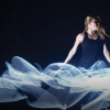 Dancer posing with lasers