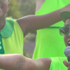 two people dressed in green singing