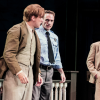 Three characters in To Kill a Mockingbird standing on stage