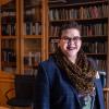 Woodzick standing in front of book shelves. 