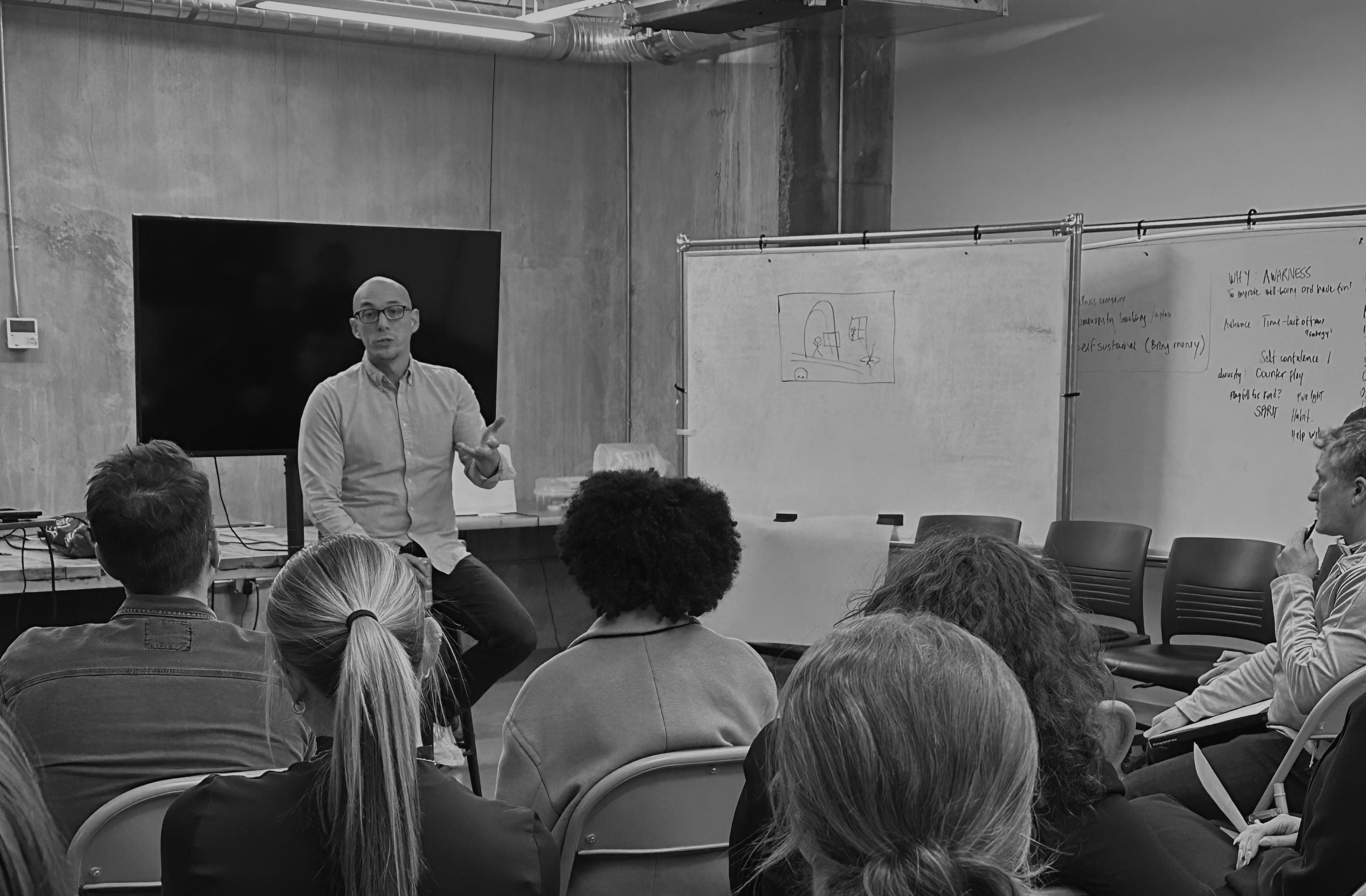 black and white photo of Faculty lecturing in class