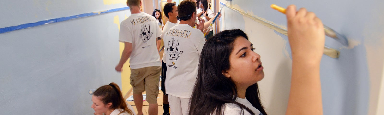 students painting a room