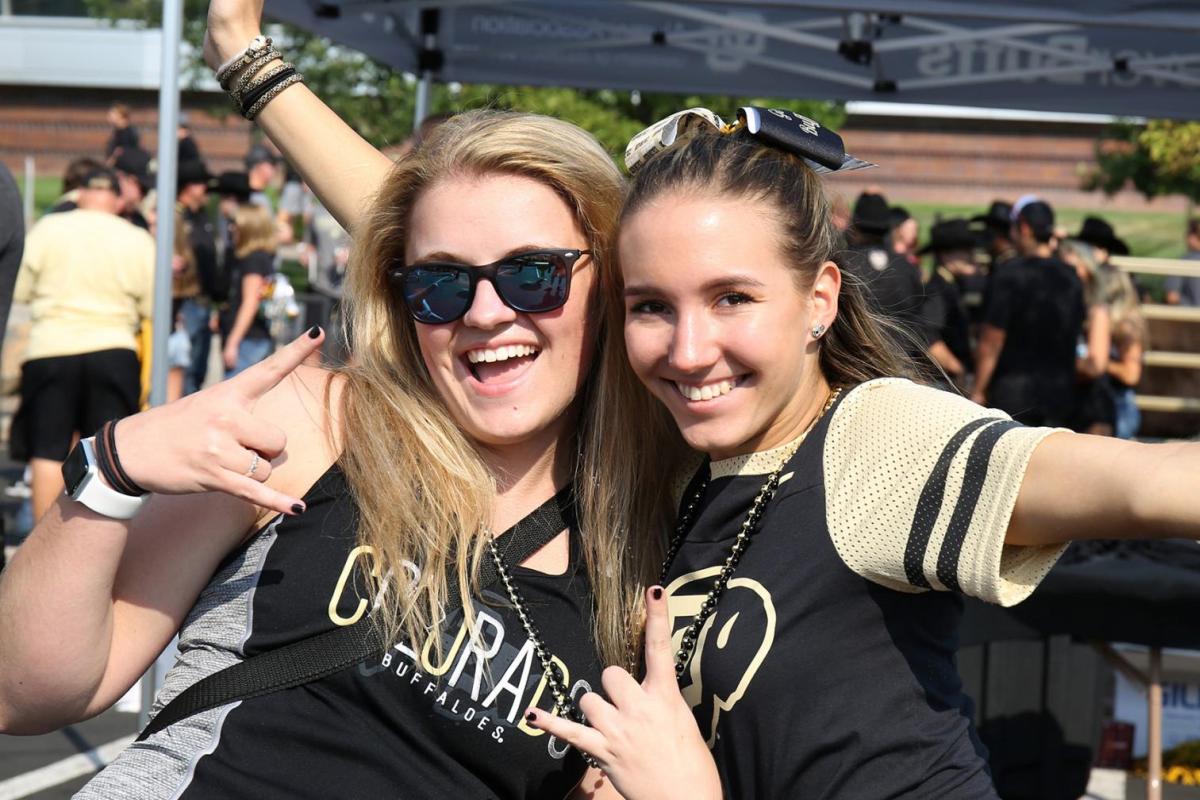 Two students in CU gear on the quad