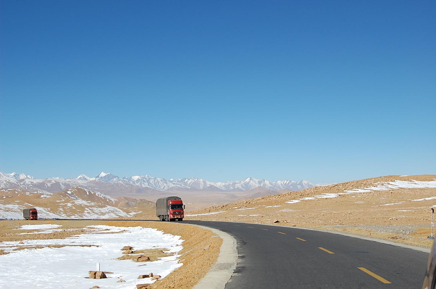 Chinese trucks laden with inexpensive exports reach the final pass before descending to the China-Nepal border at Zhangmu-Kodari