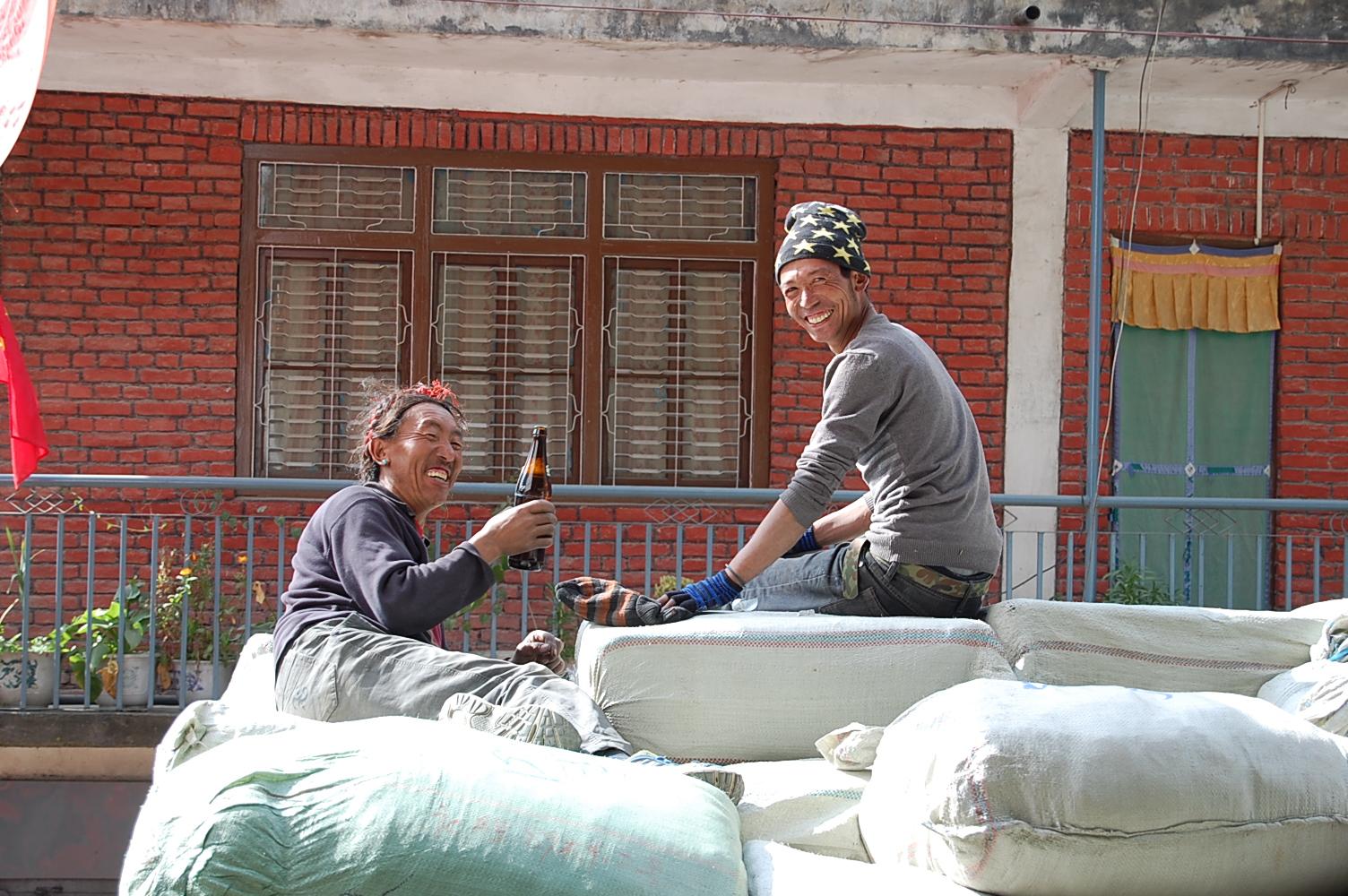 Tibetan stevedores from Tingri taking a beer break at Zhangmu while unloading Chinese garments for export to Nepal