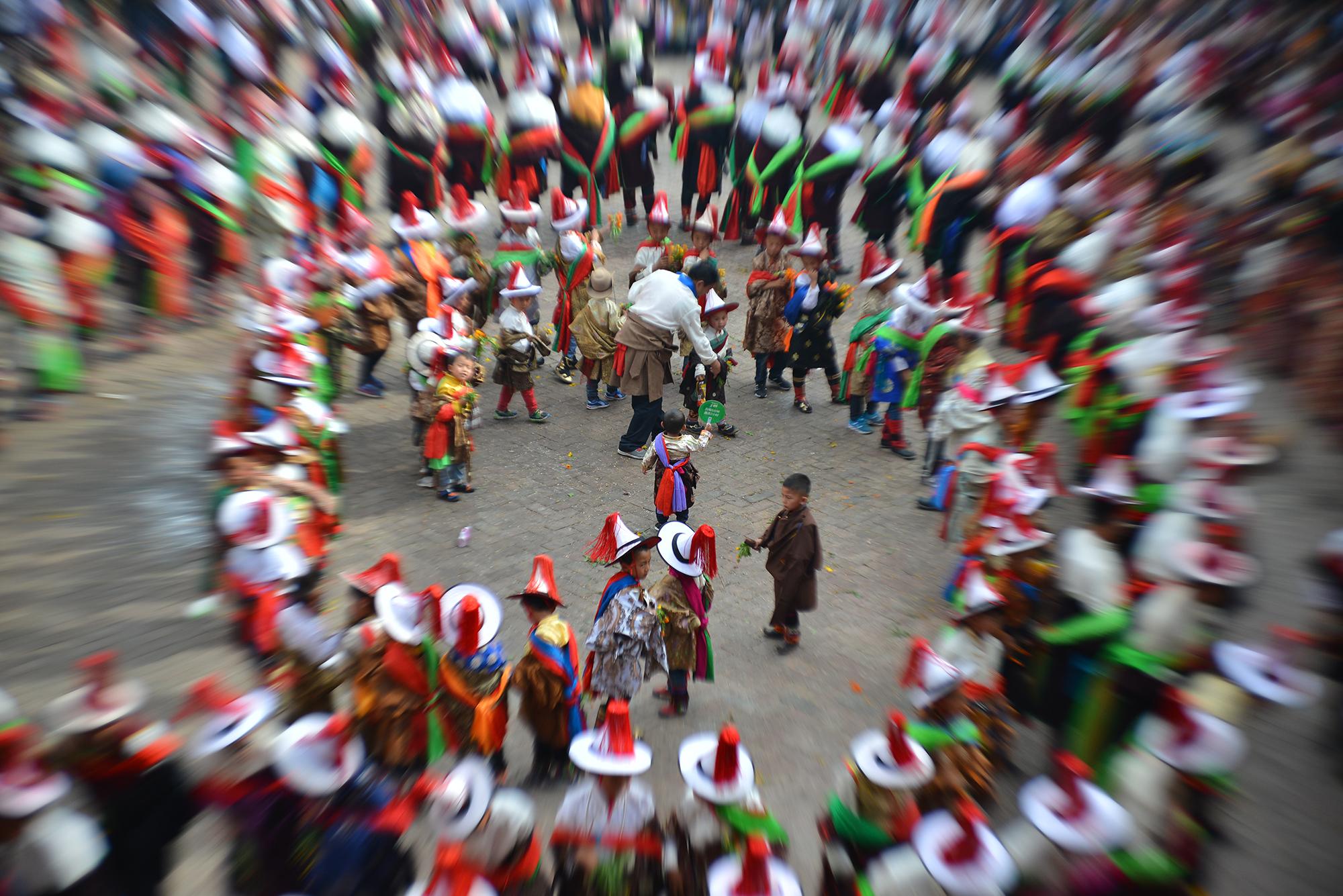 During the “Dance” or Gar (གར) portion of the festival, men and women wear fine clothes and jewelry and dance together in a swirling pattern. They eventually fill the entire courtyard.