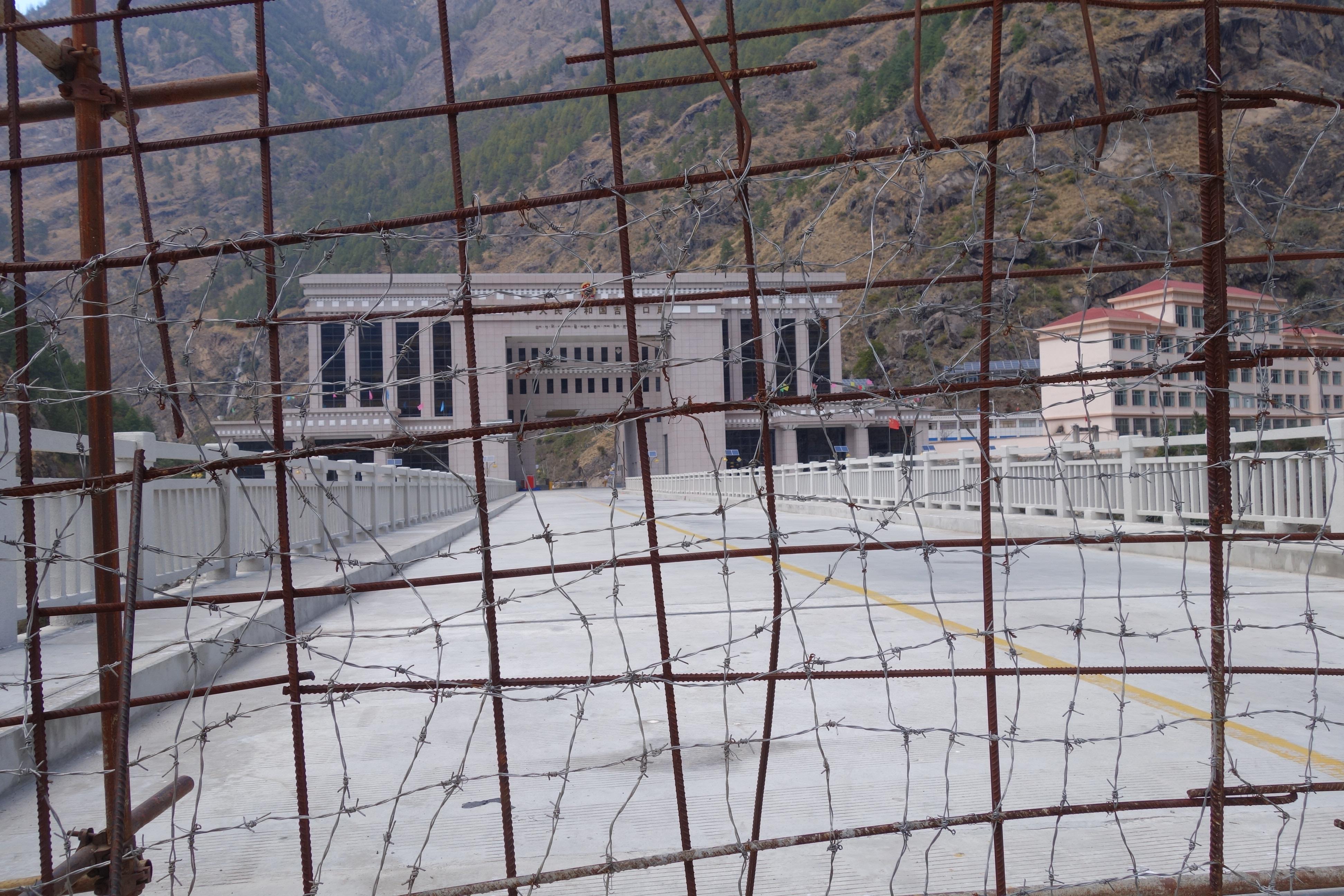 The rebar and barbed wire fence is opened numerous times per day for Nepali traders and Chinese laborers to shop at import-export markets on the Kyirong-side of the border