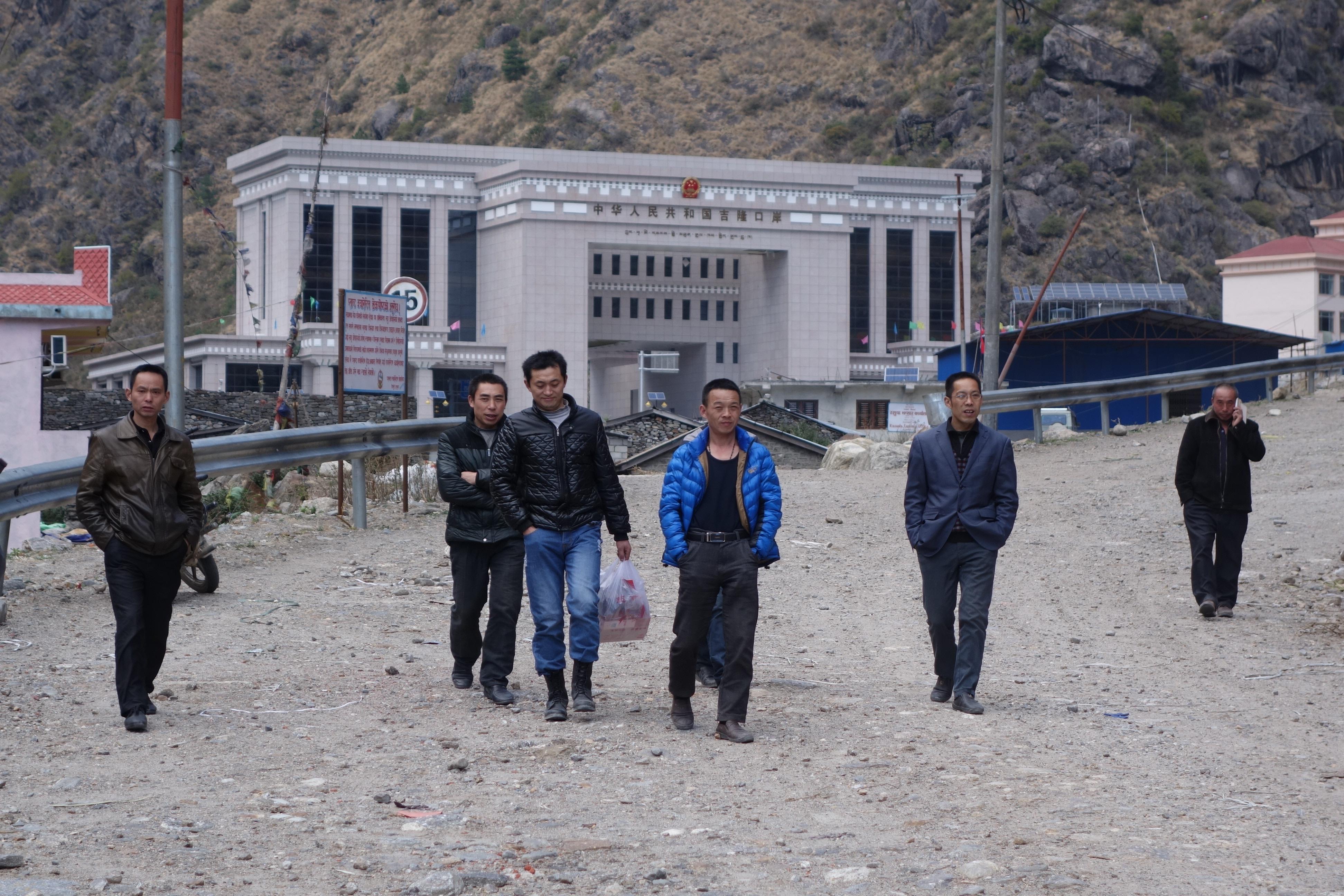 Chinese laborers from the Rasuwaghadi hydropower station return to Nepal from the Kyirong market
