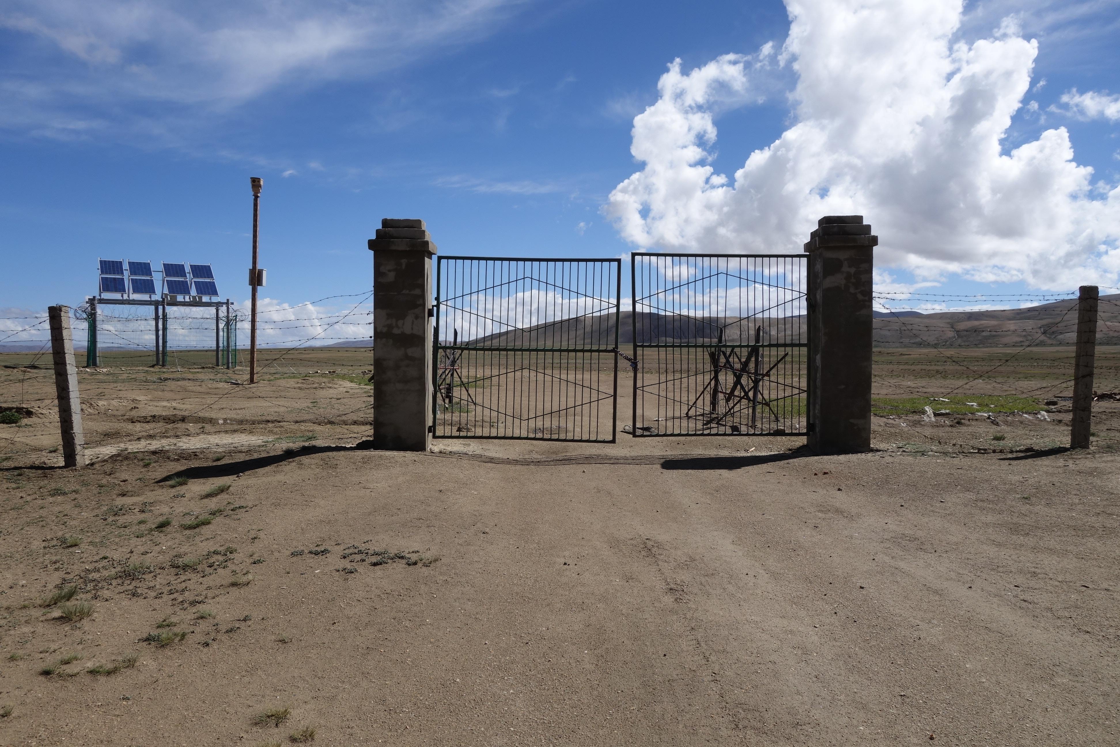 Barbed-wire fences, solar-powered cameras, and locked but unmanned gates now comprise the Nepal-China border at Neychung-Likse