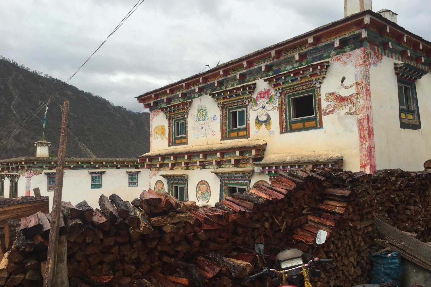 Aben Village, the first village on the Tibetan side of the border, with corn fields and surrounded by secondary pine growth.