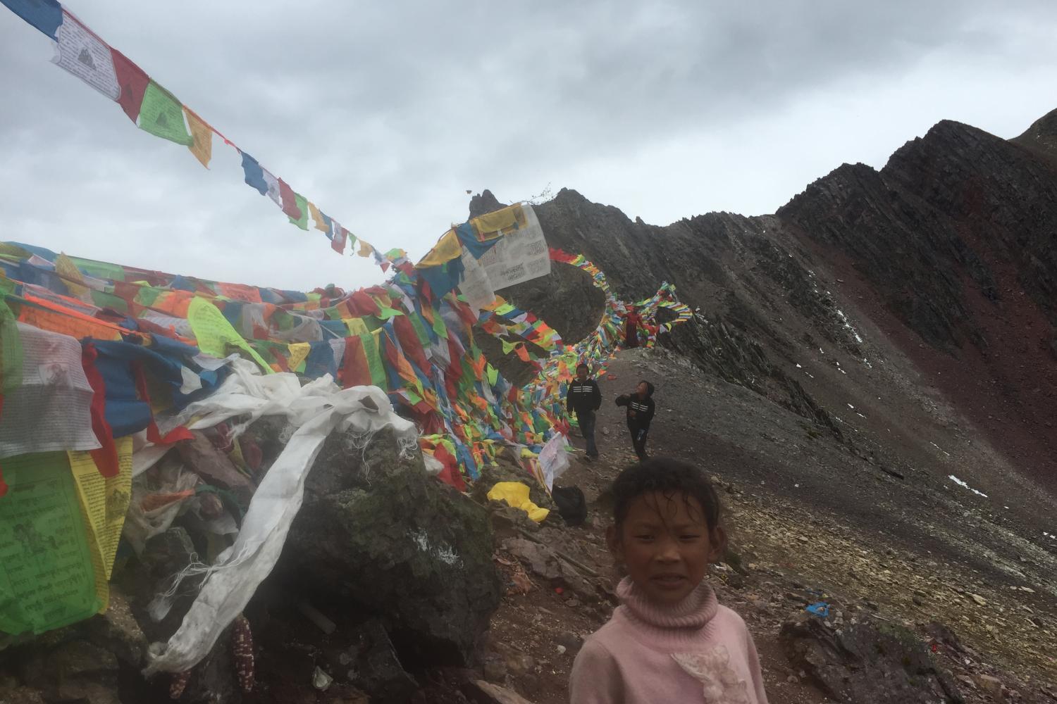 A young girl and two boys from Derong at the top of Shola.