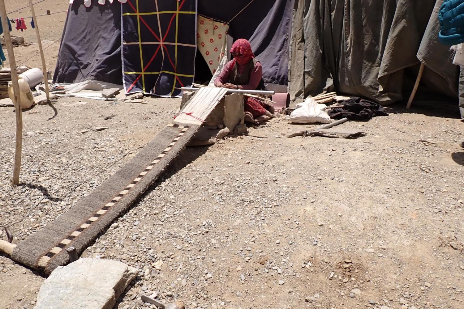 woman weaving carpet