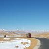 Chinese trucks laden with inexpensive exports reach the final pass before descending to the China-Nepal border at Zhangmu-Kodari