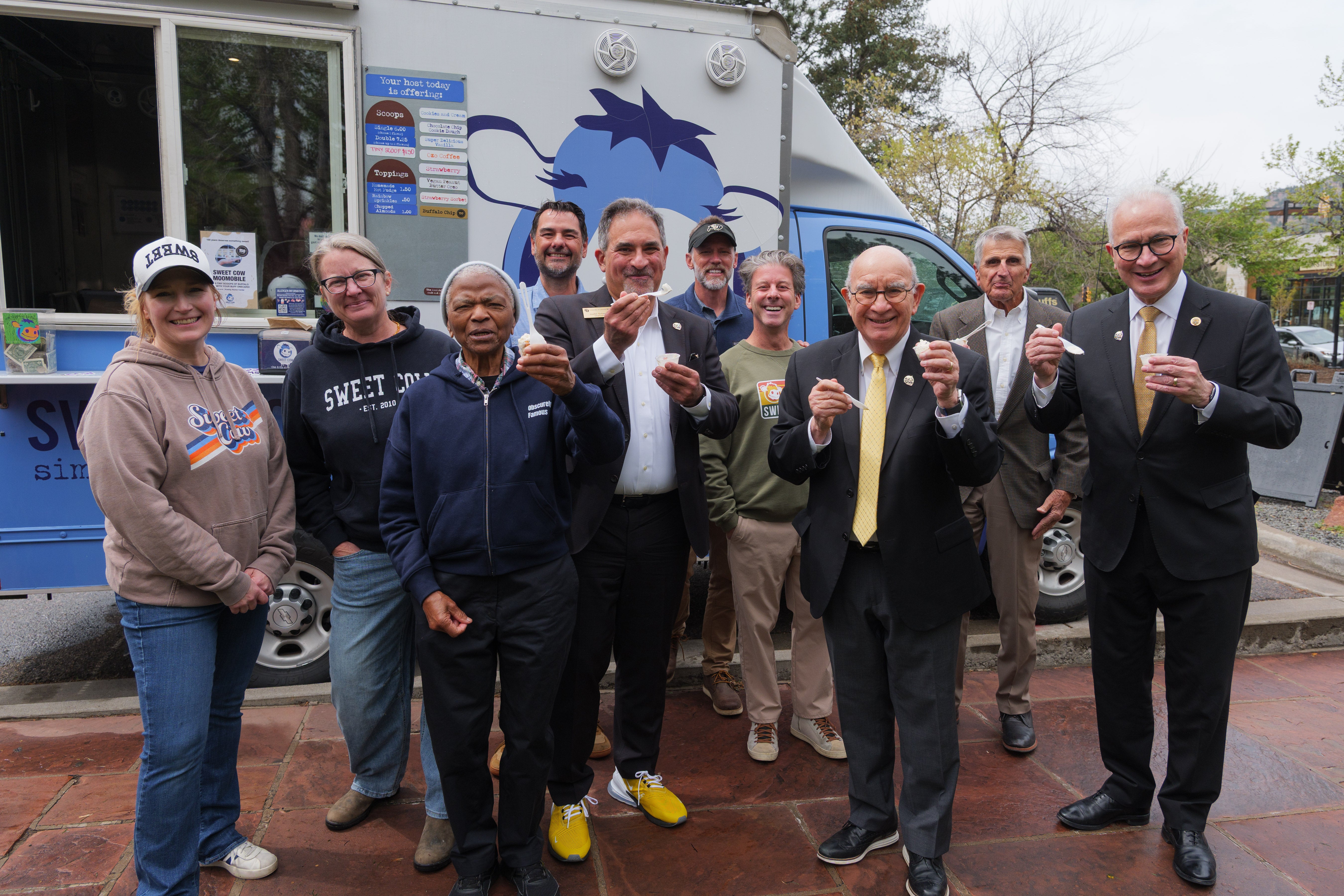 Chancellor Justin Schwartz, former CU presidents and chancellors, and campus community members enjoy a scoop of CU Boulder's 150th anniversary ice cream