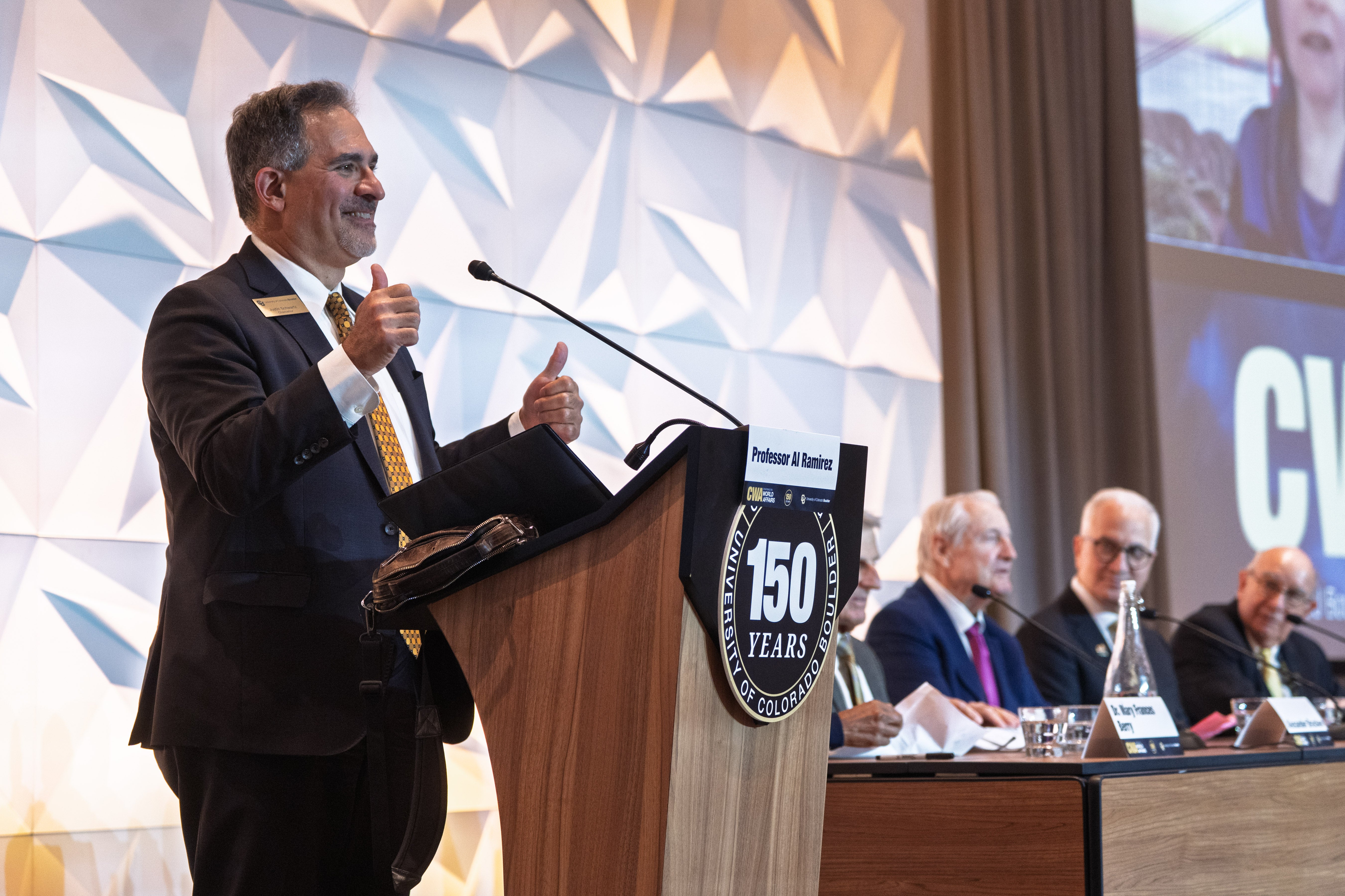 Chancellor Justin Schwartz introduces a panel of former CU presidents and chancellors