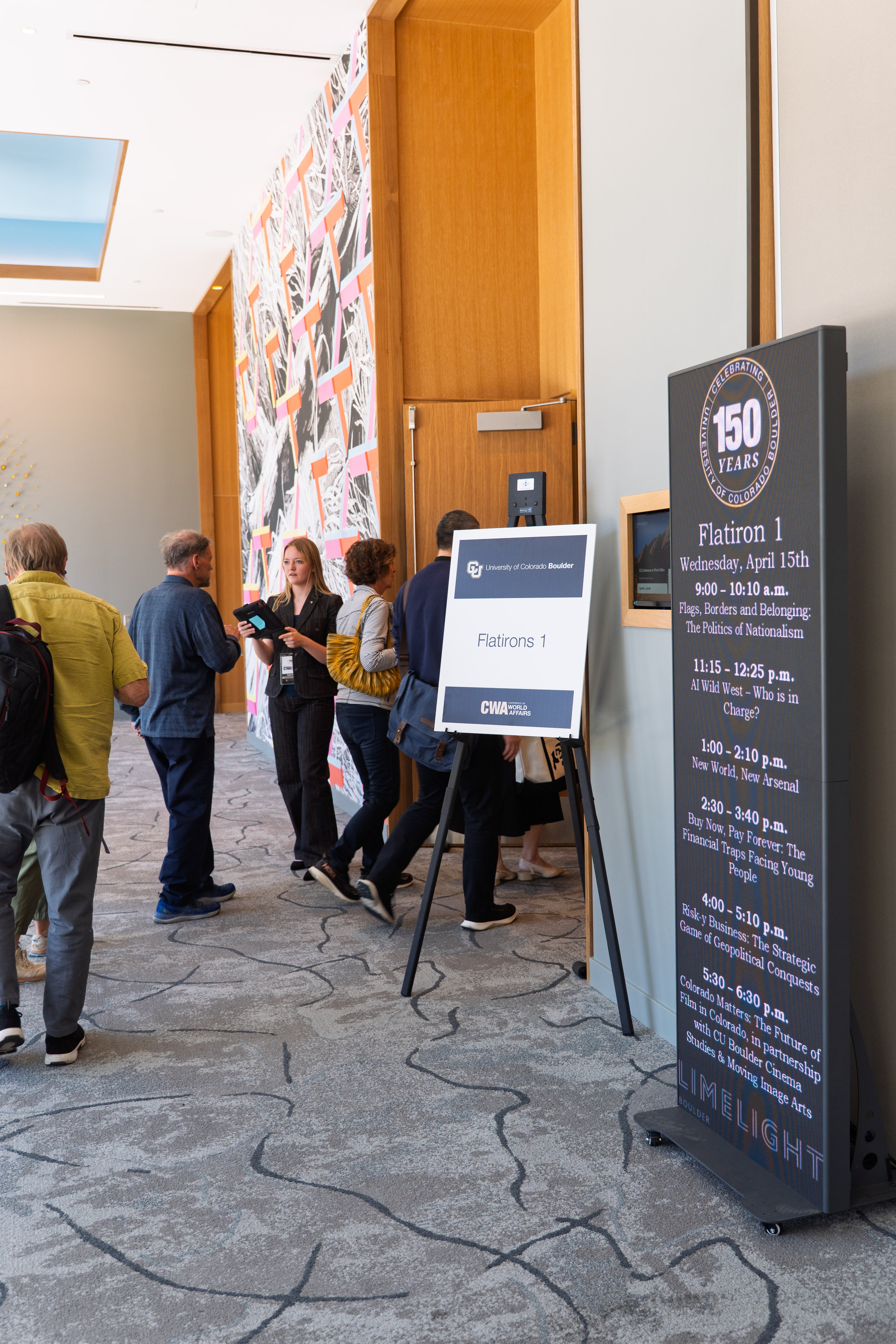 Attendees line up to enter the Flatiron 1 room for a panel