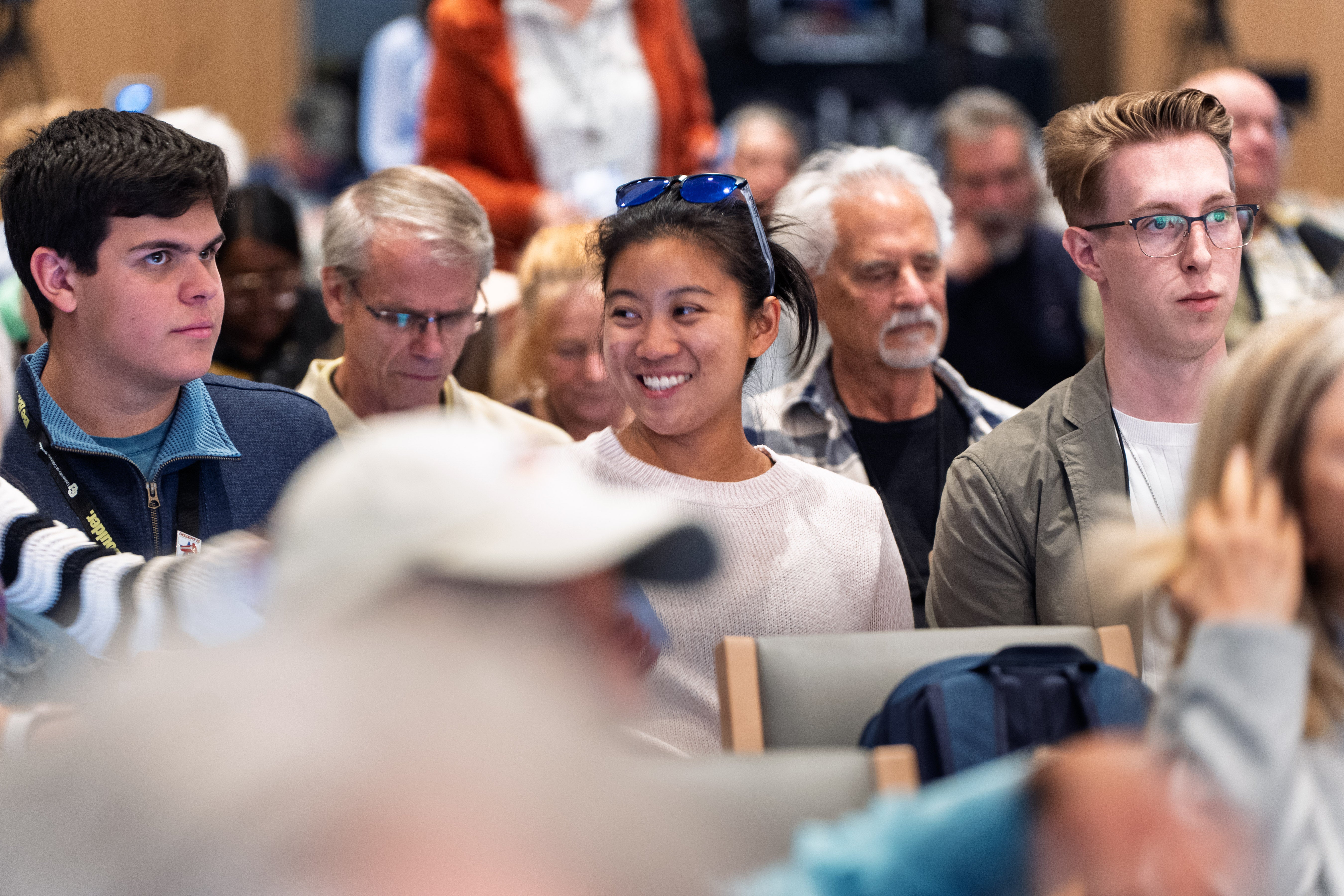 in-person attendees listen to a panel