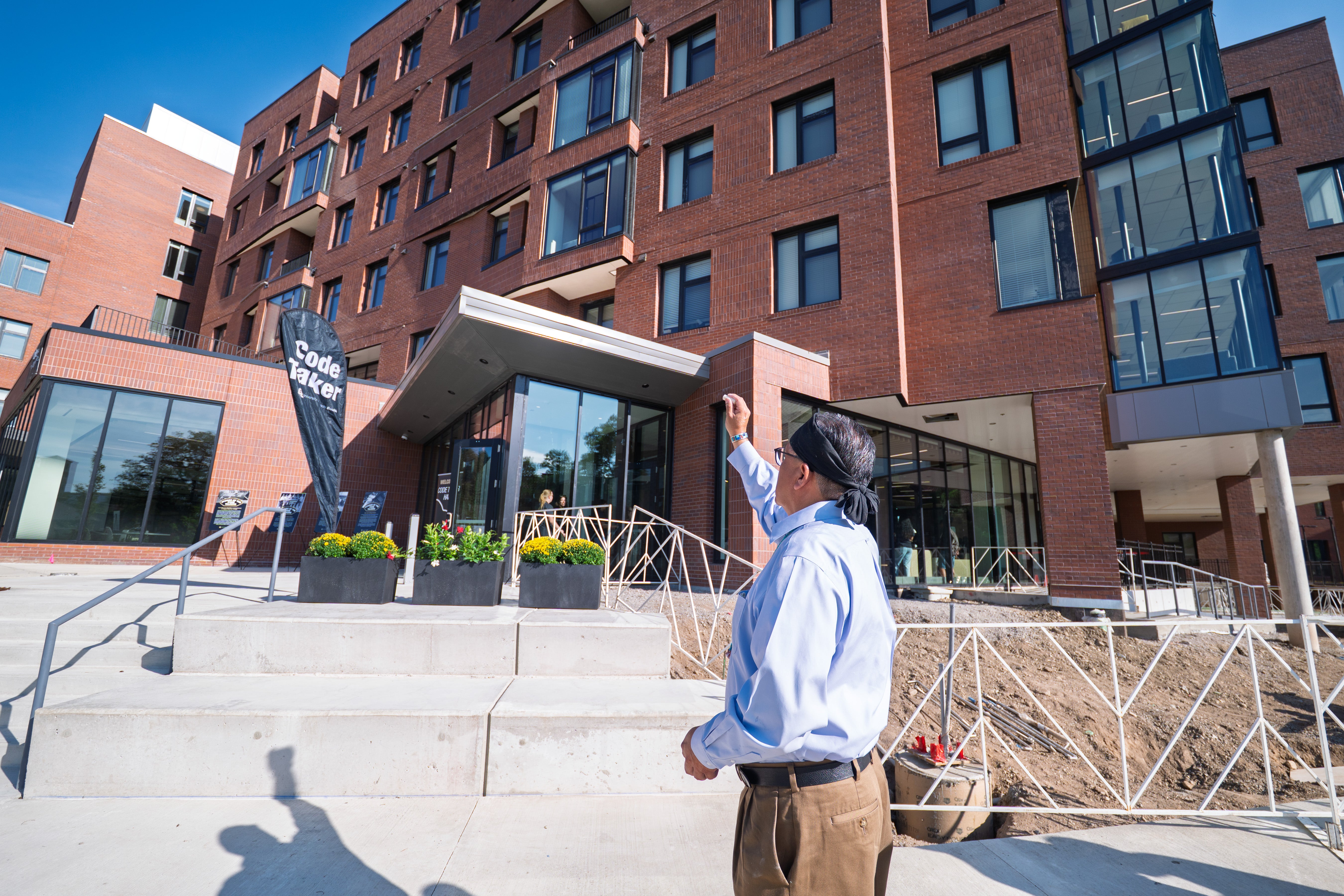 Justin Jones of the Navajo Nation sprinkles ground corn around the new Code Talker Hall