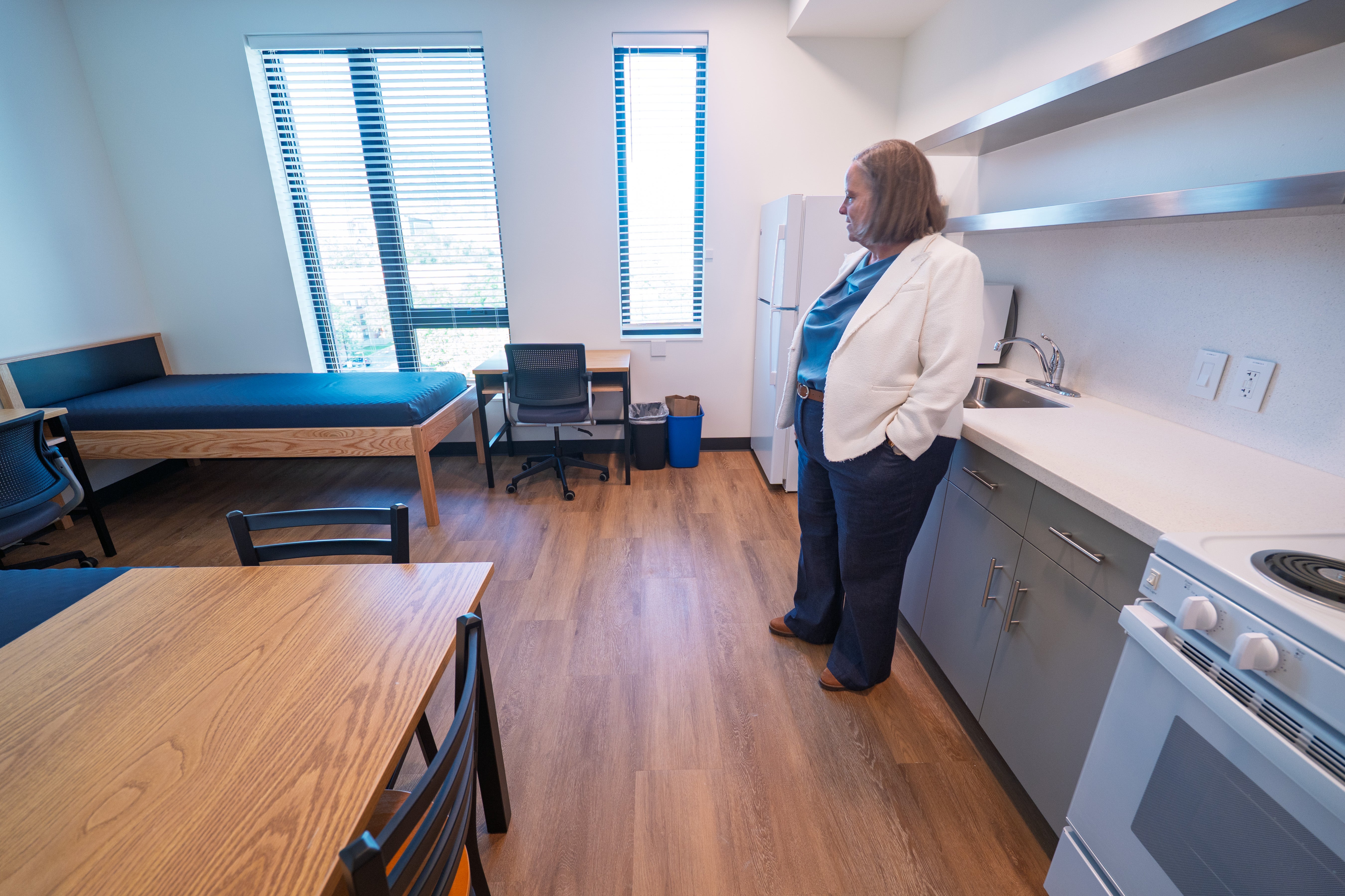 CU Boulder Provost Ann Stevens looks over a double room at the new Code Talker Hall.
