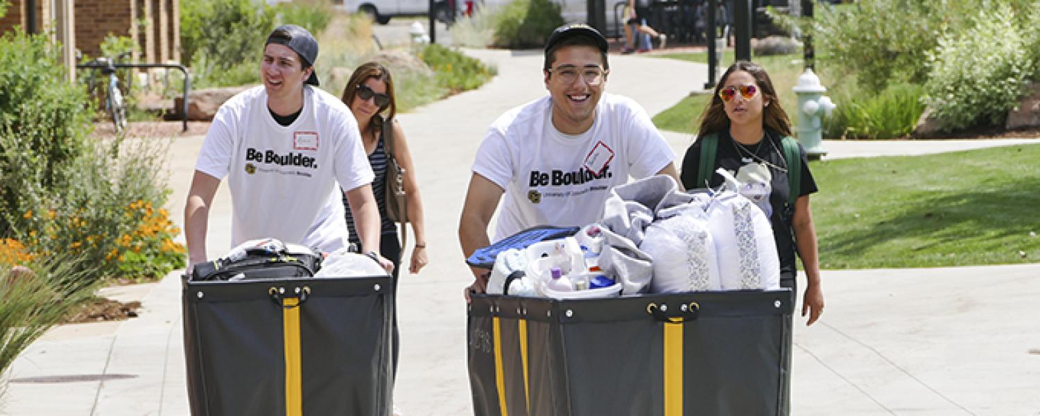  Students pushing carts of their belongings for move in day