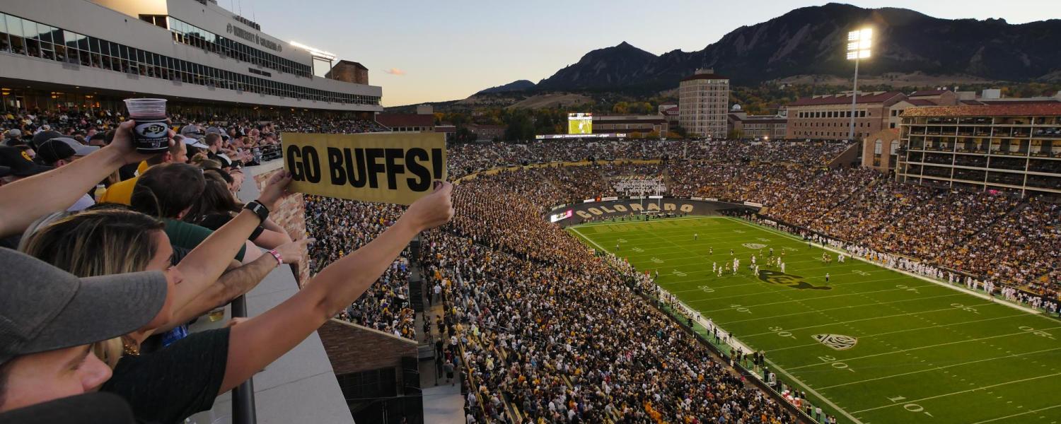 Folsom Field is packed with fans as the sun sets behind the Flatirons.