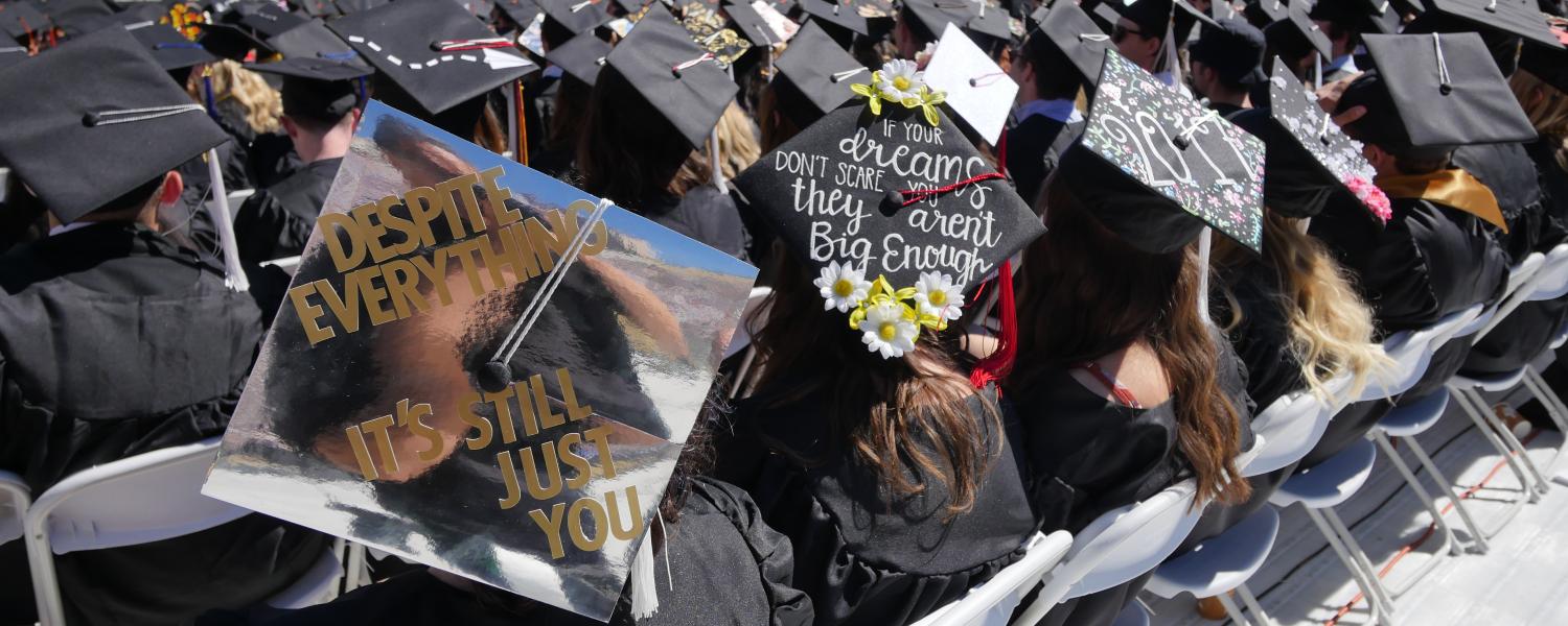 Graduates sit in rows at commencement ceremony