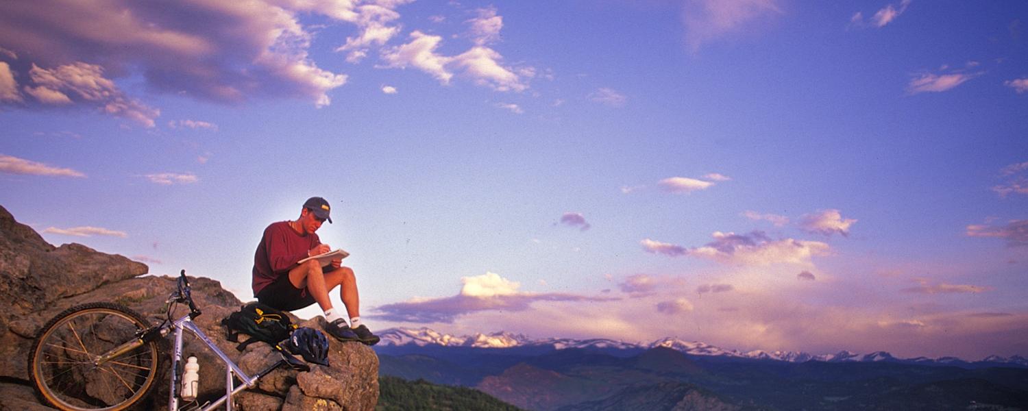 Biker on mountain top.