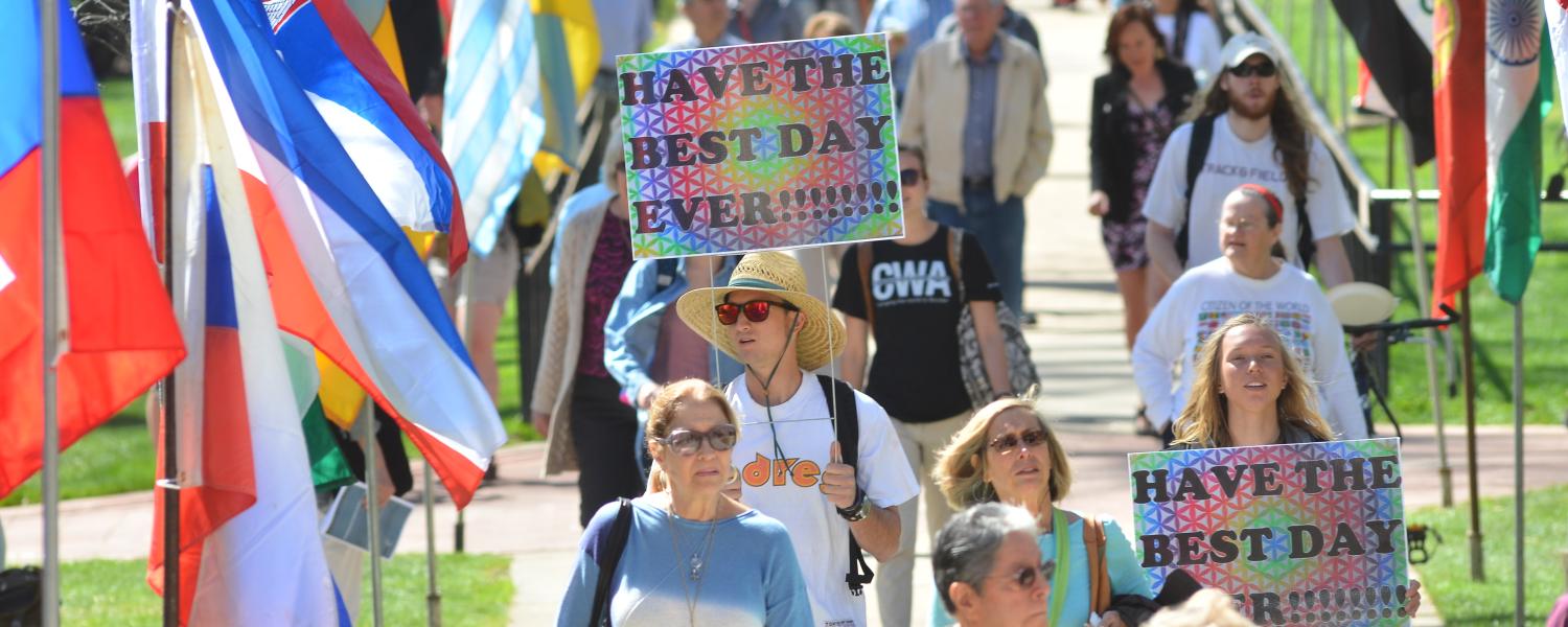 Students hold 'Have the best day ever!' signs during 2015 CWA procession