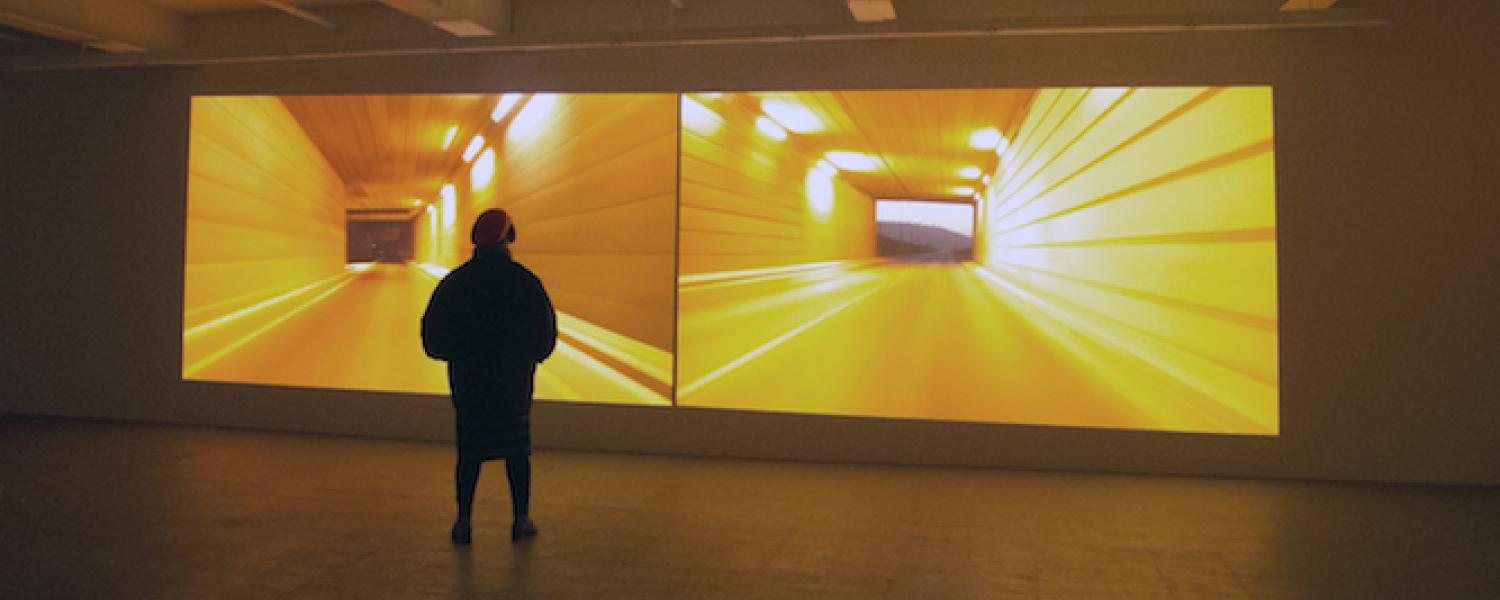 Man stands in front of "Kissing Point" installation