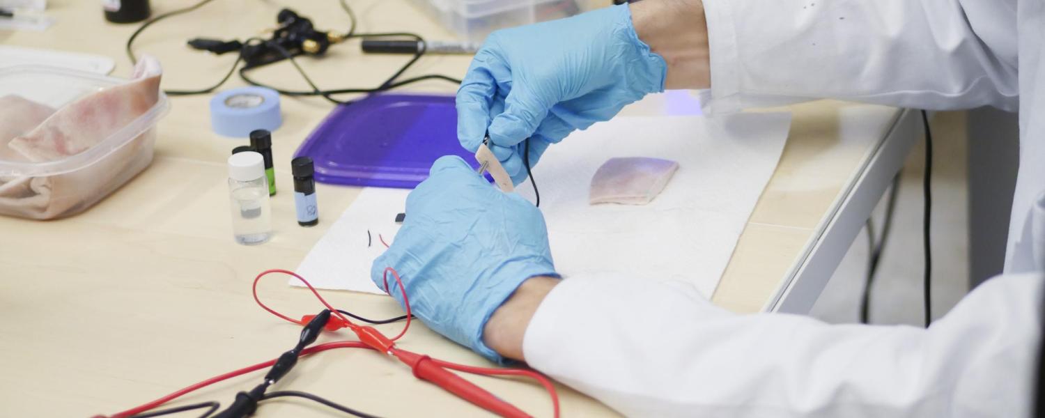 A CU Boulder researcher works on a project in a lab.