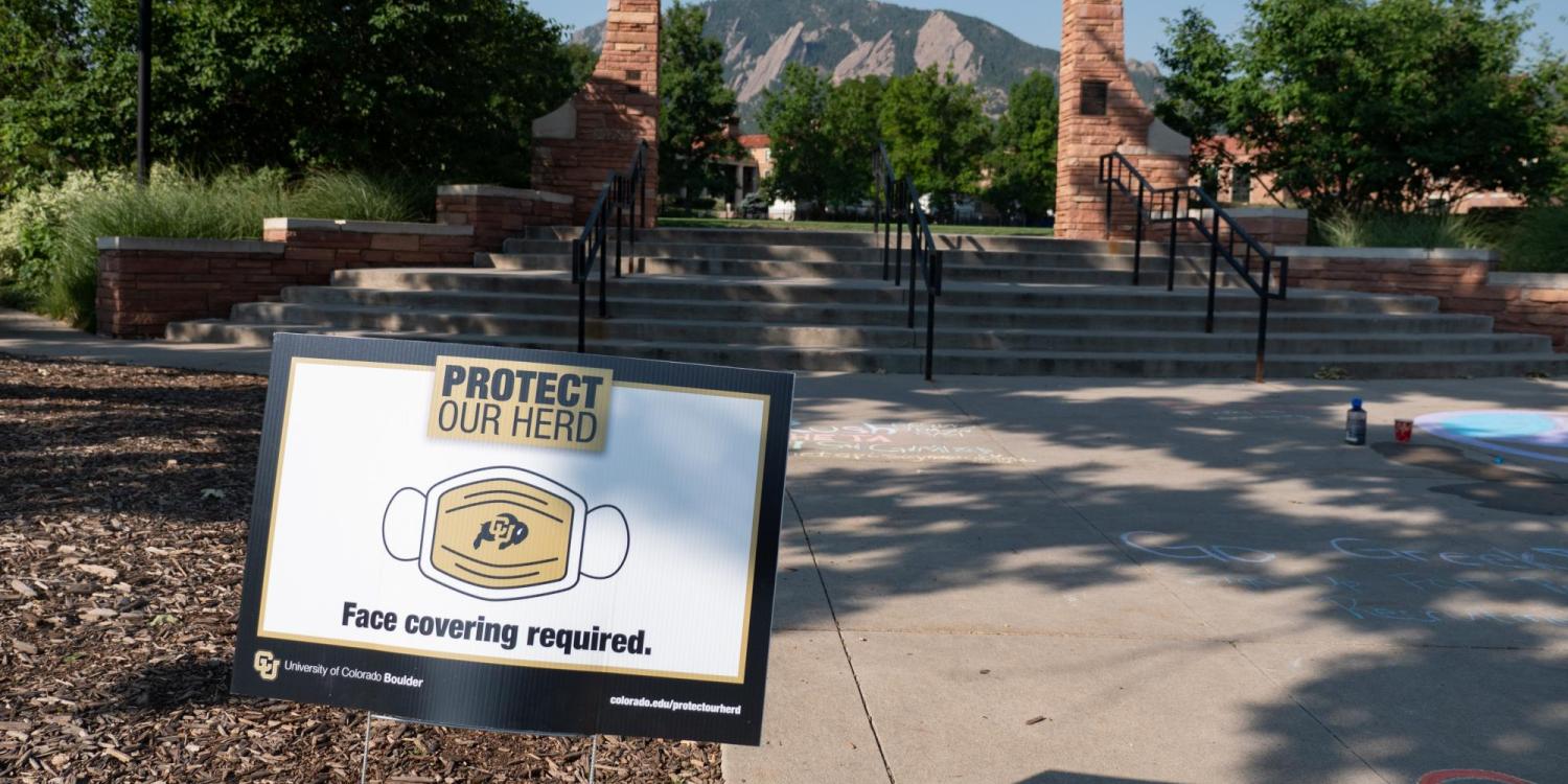 A Protect Our Herd–face covering required sign at the entrance of Farrand Field