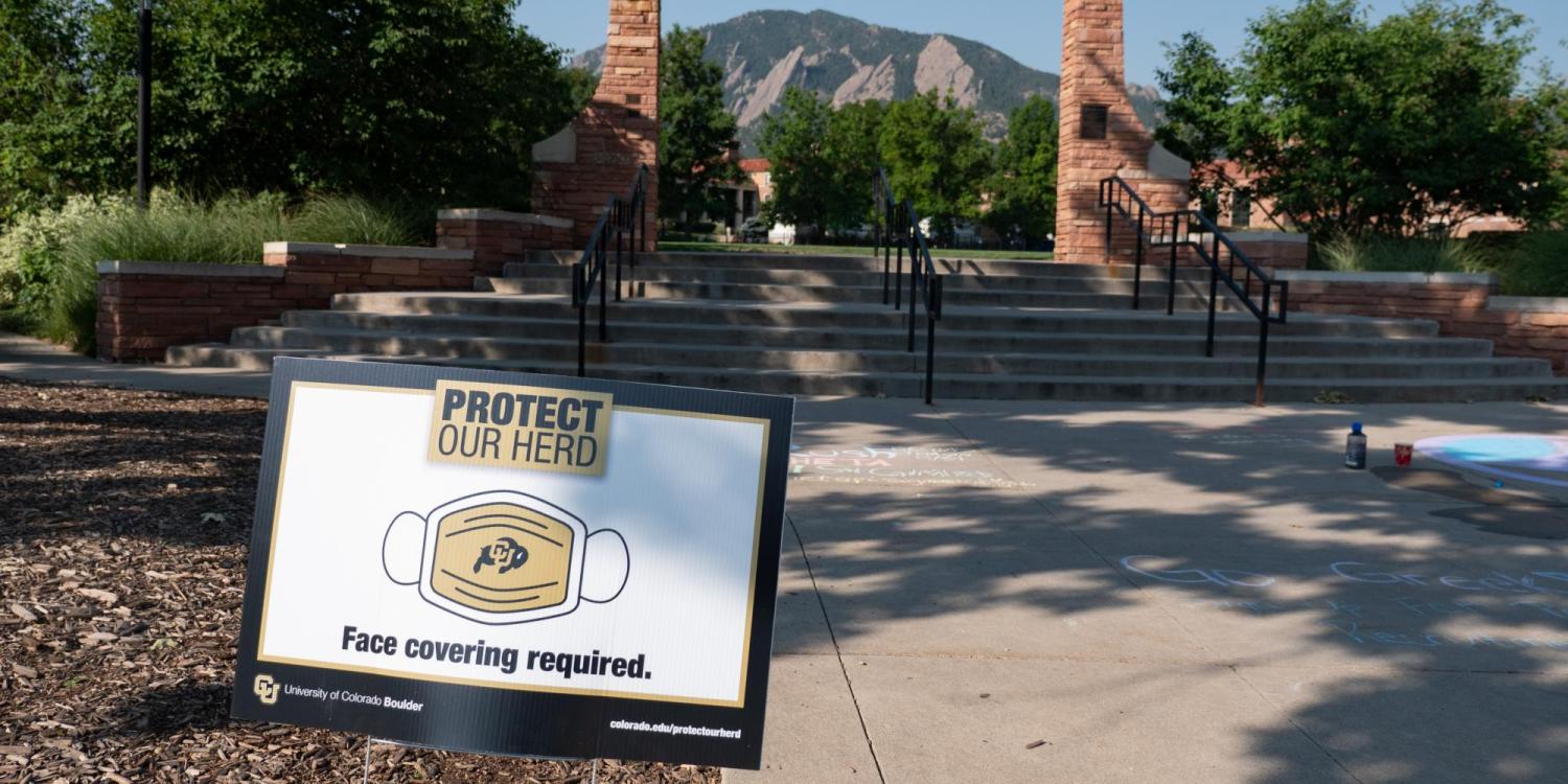 A Protect Our Herd–face covering required sign at the entrance of Farrand Field