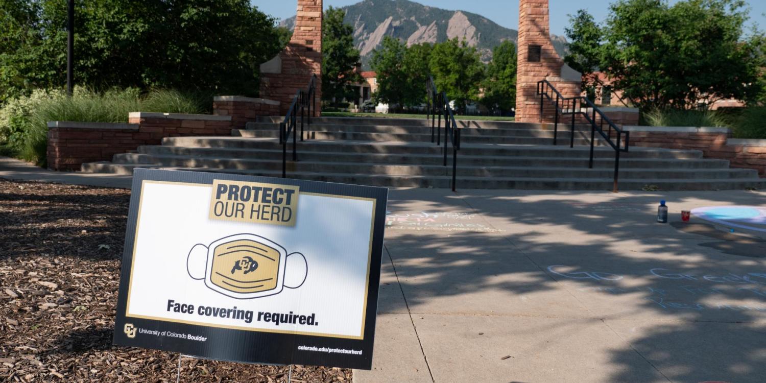 A Protect Our Herd–face covering required sign at the entrance of Farrand Field