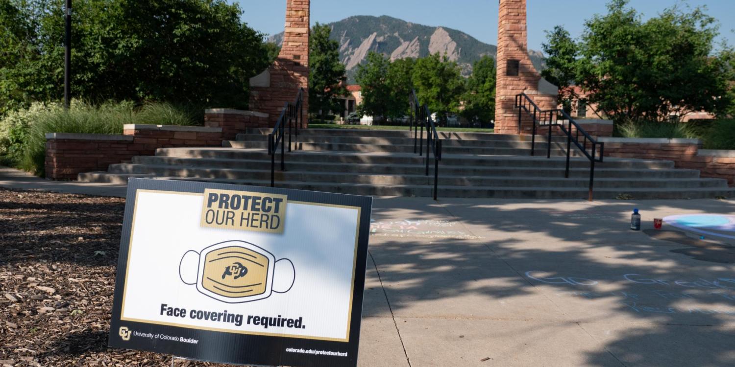 A Protect Our Herd–face covering required sign at the entrance of Farrand Field