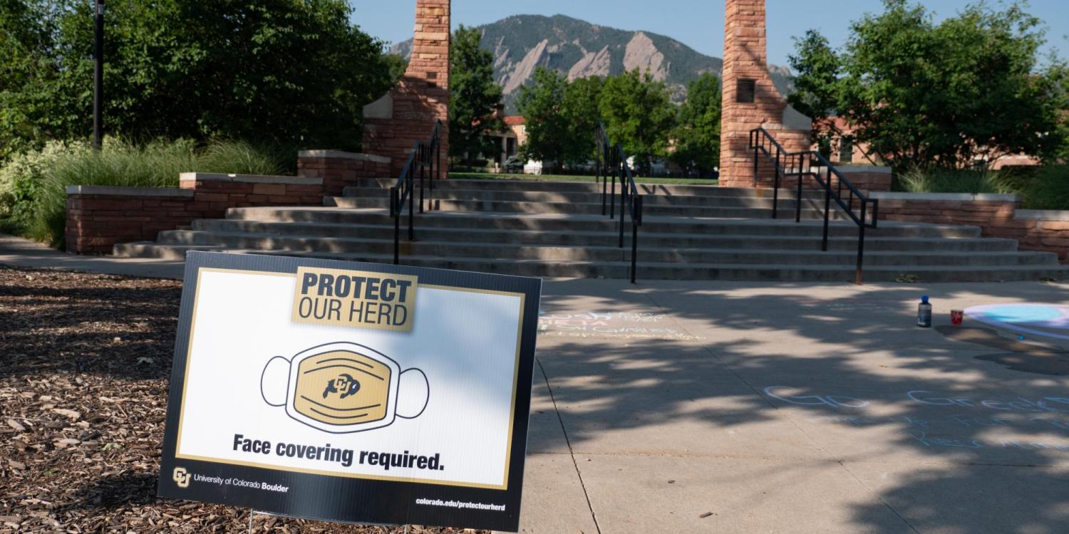 A Protect Our Herd–face covering required sign at the entrance of Farrand Field