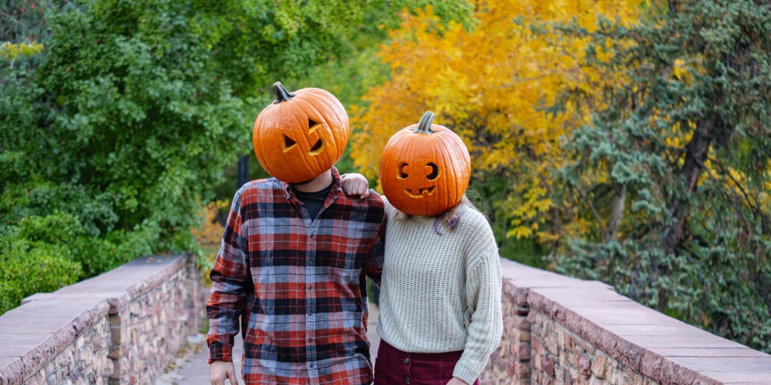 Students Mackenzie Hernandez and Nathan Smith don jack-o-lanterns on their heads