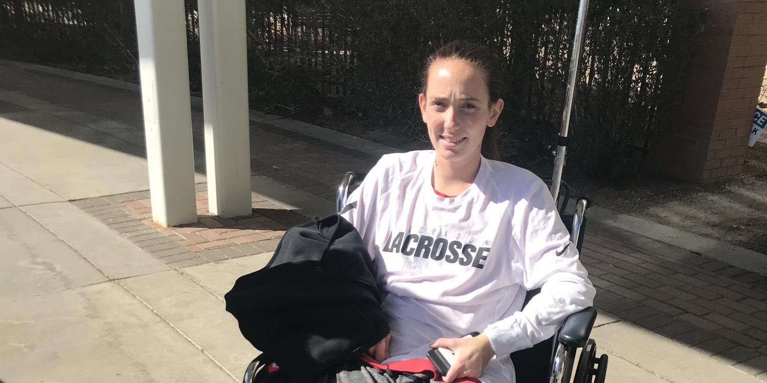 Aine Williams in wheelchair sporting a CU Lacrosse T-shirt 