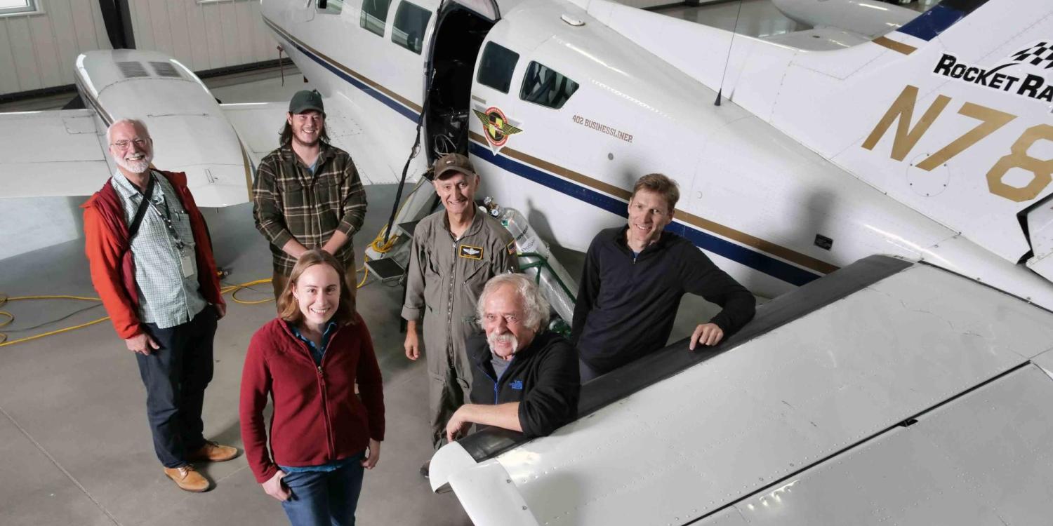 Members of INSTAAR, the University of Maryland and TOFWERK group photo in a hangar