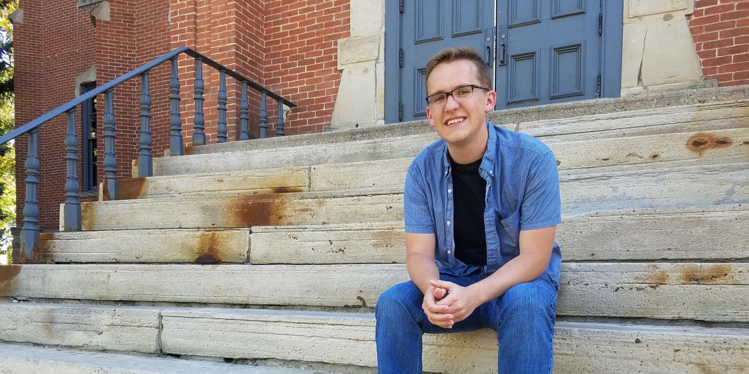 Austin Braun on the steps of Old Main