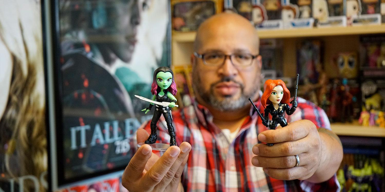Christopher Bell poses with Gamora and Black Widow action figures