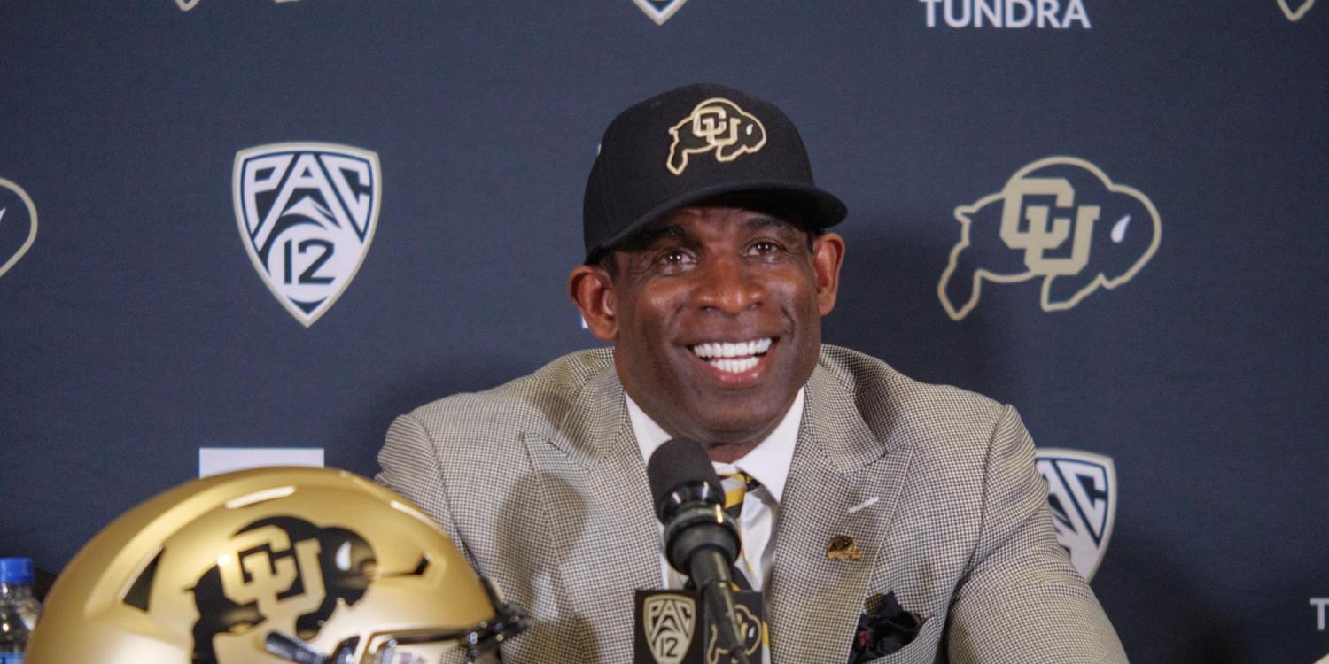 Deion Sanders (Coach Prime), smiles during a humorous moment during the press conference announcing his hiring as University of Colorado football teamÕs 28th head coach at the Touchdown Club at Folsom Field on December 4, 2022. (Photo by Glenn Asakawa/University of Colorado)