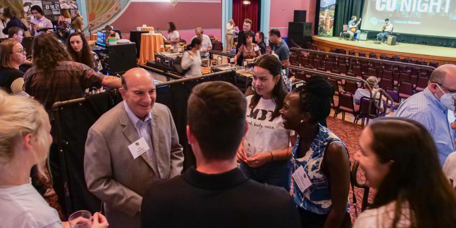 CU Boulder Chancellor Phil DiStefano, left, greets guests and students at the CU Night in Downtown Boulder event at Boulder Theater