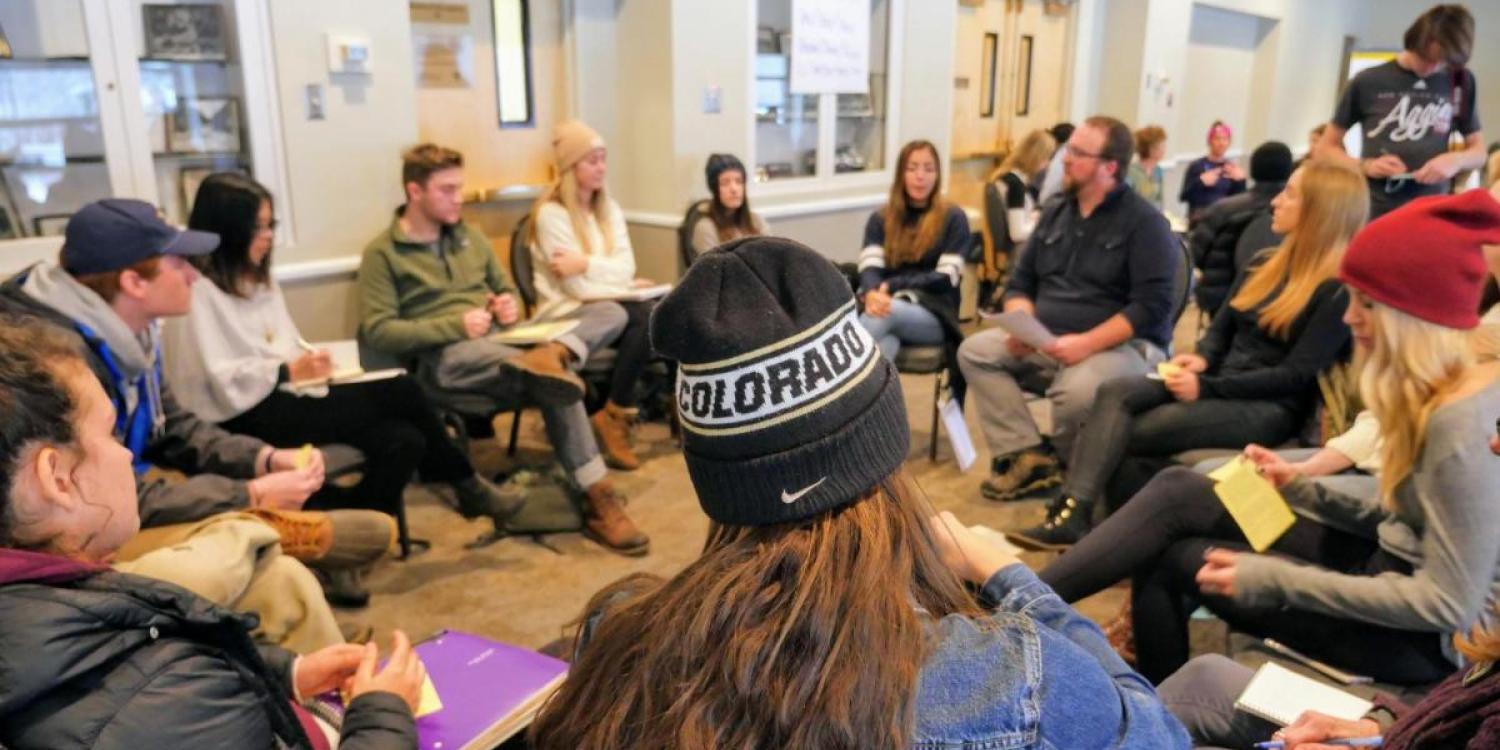 A group sits in a circle and converses at the Diversity and Inclusion Summit 2017